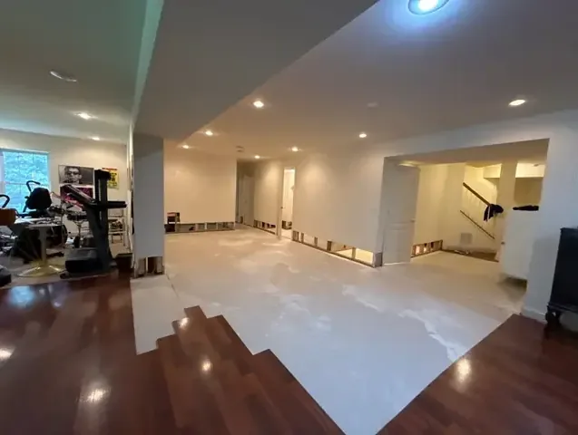 A finished basement with the base of the walls opened for drying